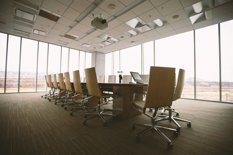 Daylit law-firm boardroom with a long wooden conference table